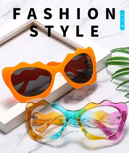 Close-up of trendy wave-shaped frame sunglasses in vibrant orange and rainbow gradient colors
