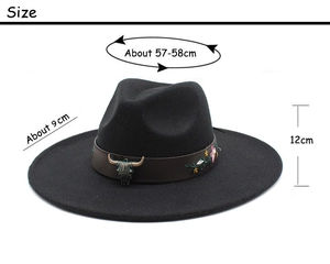 Detail of western fedora hat featuring bronze bull head buckle and floral embroidery