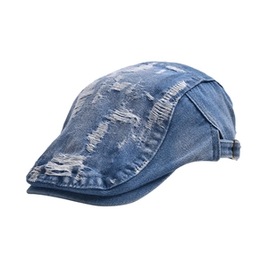 Vintage blue denim flat cap with distressed ripped details and adjustable metal buckle strap
