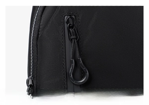 Detail of smooth black dual zippers and durable high-density nylon texture on chest bag