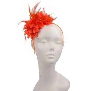 Detail of an orange fascinator featuring fabric flowers and feathers on a headband