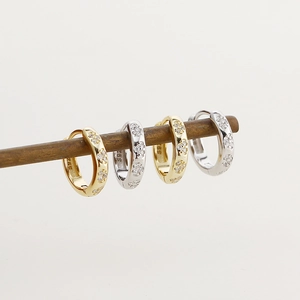 Detailed view of gold and silver S925 sterling silver hoop earrings with pavé crystals