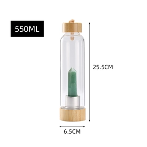 Detailed view of 550ml glass water bottle with bamboo lid and green crystal pillar inside