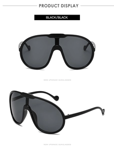 Close-up detail of trendy oversized black sunglasses with a seamless integrated frame