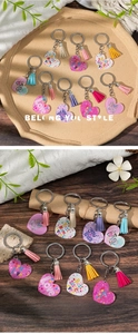 Detail view of heart-shaped acrylic keychains with colorful tassels for Mother's Day gifts