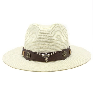 Detail of a straw cowboy hat with a brown leather band and silver bull head ornament