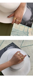 Detail of handmade freshwater pearl rings set worn by model with gold coin accents