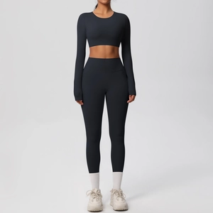Detail of high-waisted black yoga set with long sleeve crop top and leggings