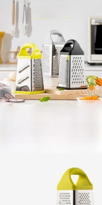 Detail of a 4-sided stainless steel grater with a collection box in a kitchen setting