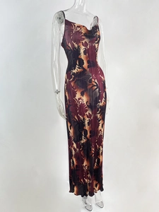 Detail of burgundy abstract print maxi dress featuring pleated fabric and slim fit design