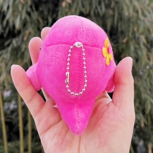 Detailed back view of pink plush whale keychain showing silver ball chain and flower