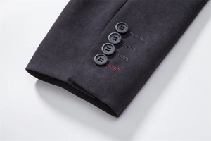 Detail of suit sleeve cuffs with four buttons and red contrast stitching on wool coat