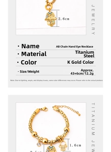 Detail view of gold-tone titanium steel Hamsa hand pendant necklace and matching bracelet