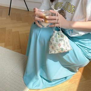 Close-up of a floral drawstring pouch with Sozakka brand label on cotton fabric