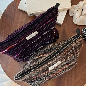 Detail of wool tweed pouches in purple and grey with simple wish woven labels
