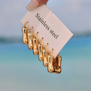 Polished gold U-shaped stainless steel earrings set for women featuring smooth curved designs