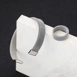 Silver mesh weave stainless steel bracelet and ring set on white marble block