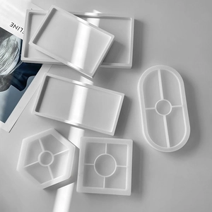 Detailed overhead view of various geometric translucent silicone molds for DIY resin coasters