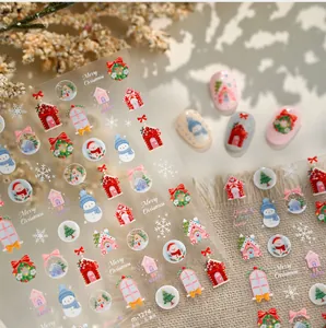 Détails d'autocollants nail art de Noël avec motifs de bonhomme de neige et maison
