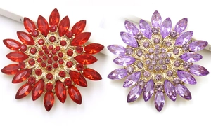 Detail of red and purple crystal sunflower brooches with gold alloy base and facets