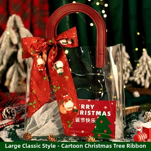 Detail of Christmas gift bag with red leather handle and festive printed silk ribbon