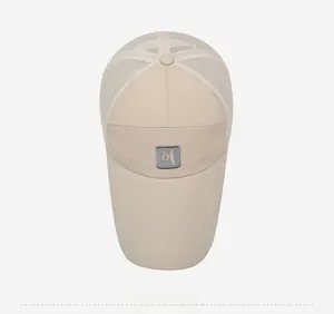 Top-down view of a breathable beige mesh baseball cap with M patch and Fashion text