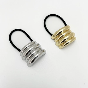 Close-up of gold and silver minimalist shell hair ties with elastic black bands