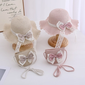 Detail of woven straw hat and matching purse with lace trim and elegant satin bows