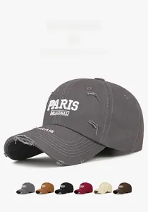 Close-up of vintage distressed baseball cap with PARIS embroidery and worn-out details