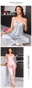 Detail of silk satin pajama set with lace V-neck top and trousers in grey and pink