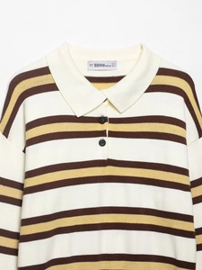 Detail of Polo collar with two buttons on a striped knit sweater in beige and yellow