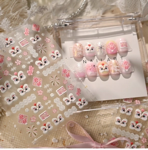 Detailed view of pink lion dance nail art stickers and 3D floral embossed designs