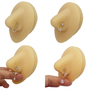 Gold plated heart and butterfly nose studs set with clear zircon on silicone model