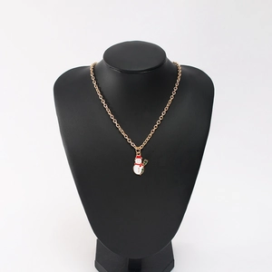 Detail of Christmas snowman pendant with red hat and scarf on gold chain necklace