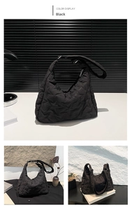 Detail of black quilted shoulder bag featuring star stitching and spacious tote design