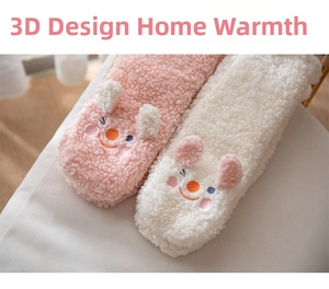 Close-up of pink and white coral fleece socks featuring cute 3D cartoon animal designs