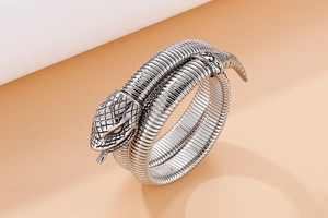 Macro shot of cobra snake bracelet detailing retro silver scales and carved head