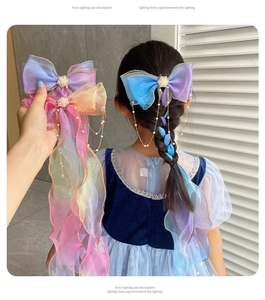 Detail of colorful organza bow hair clip with faux pearl fringe for girl hairstyles