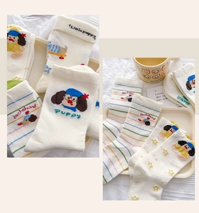 Close-up of knit cotton crew socks featuring cute cartoon dachshund dog patterns