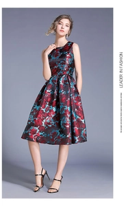 Detailed view of sleeveless floral jacquard dress with vibrant red and blue patterns