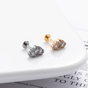 Macro shot of G23 titanium labret studs with fan-shaped cubic zirconia flower design