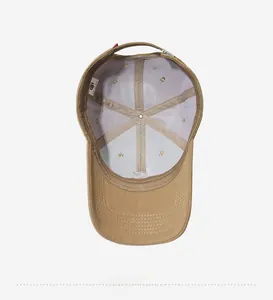 Detail view of the interior stitching and laundry tag of a khaki cotton baseball cap