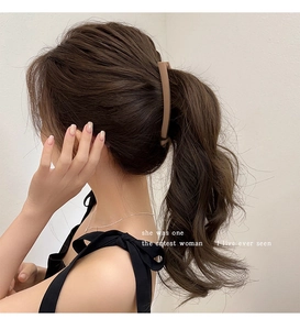 Close-up of matte banana hair clip in latte brown color holding a ponytail hairstyle