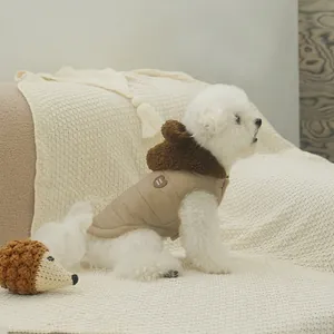 Quilted khaki dog winter vest with cute bear ear hood and heart patch on warm knit rug