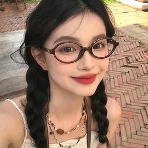 Nahaufnahme der Schildpatt-Sonnenbrille mit Retro-Ovalrahmen, getragen von einem Modell