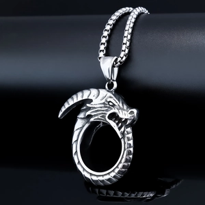 Macro view of stainless steel dragon head pendant with detailed scales on black background