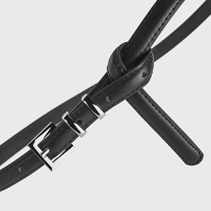 Minimalist black leather skinny belt for women featuring a stylish silver metal buckle