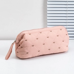 Pink quilted hair dryer organizer bag with bow embroidery and carry handle