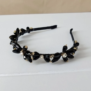 Close-up of luxury black crystal beads and rhinestones on a handmade headband