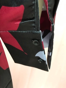 Detail of multi-color satin shirt cuff featuring fine stitching and smooth twill texture
